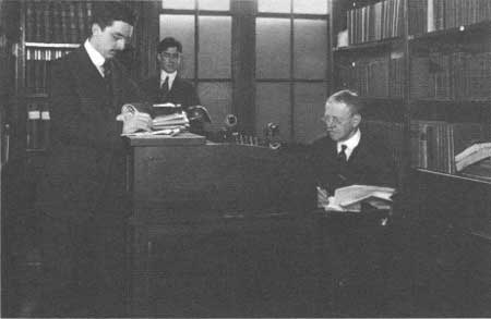 Edison behind desk