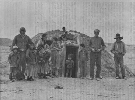 Navajo family and hogan