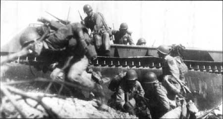 Marines jump off an amphibious tractor