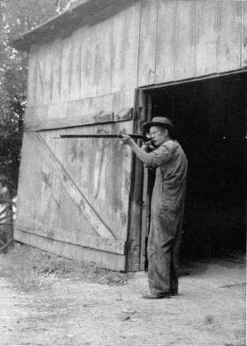 gentleman firing rifle